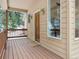 Inviting front porch with wood decking, exterior lighting, and a glimpse of the surrounding nature at 1580 Santa Fe Mountain Rd, Evergreen, CO 80439