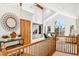 Bright living room featuring vaulted ceilings, a modern fireplace, and access to outdoor deck with mountain views at 1580 Santa Fe Mountain Rd, Evergreen, CO 80439