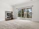 Spacious living room features a stone fireplace and sliding glass doors leading to a private outdoor space at 1580 Santa Fe Mountain Rd, Evergreen, CO 80439