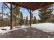 Covered patio with stone flooring provides an outdoor space to enjoy mountain views at 1580 Santa Fe Mountain Rd, Evergreen, CO 80439