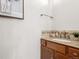 Powder room featuring a granite countertop, a wood cabinet, and a decorative art print at 1580 Santa Fe Mountain Rd, Evergreen, CO 80439