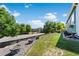 Well-maintained backyard with lush lawn, planter boxes, and mature trees at 19771 E Wesley Pl, Aurora, CO 80013
