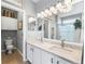 Bathroom featuring double vanity, large mirror, and tiled floors at 19771 E Wesley Pl, Aurora, CO 80013