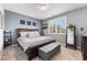 Neutral bedroom featuring large bed with gray ottoman and a decorative wall at 19771 E Wesley Pl, Aurora, CO 80013