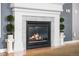 Close-up of a fireplace with tile surround, a decorative mantel, and green plants on pedestals at 19771 E Wesley Pl, Aurora, CO 80013