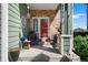 Inviting front porch featuring a red door, seating, and charming decorative accents at 19771 E Wesley Pl, Aurora, CO 80013