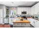 Bright kitchen with white cabinets, stainless steel appliances, kitchen island and hardwood floors at 19771 E Wesley Pl, Aurora, CO 80013