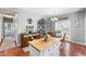 Charming eat-in kitchen with hardwood floors, kitchen island and coffee bar at 19771 E Wesley Pl, Aurora, CO 80013