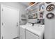 Bright laundry room featuring side by side washer and dryer with storage shelves at 19771 E Wesley Pl, Aurora, CO 80013