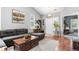 Bright living room with a gray sectional couch, hardwood floors, and a fireplace at 19771 E Wesley Pl, Aurora, CO 80013