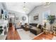 Spacious living room with high ceilings, a fireplace, a large sectional couch, and hardwood floors at 19771 E Wesley Pl, Aurora, CO 80013