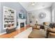 Open living room with fireplace, built in bookshelves, large sectional couch, and decor at 19771 E Wesley Pl, Aurora, CO 80013