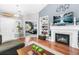 Inviting living room with hardwood floors, a fireplace, built-in shelving, and stylish decor at 19771 E Wesley Pl, Aurora, CO 80013