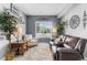 Comfortable sitting room with a leather loveseat, accent chair, decorative accents, and natural light at 19771 E Wesley Pl, Aurora, CO 80013