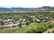Breathtaking aerial view of a community with lush greenery, mountains, and spacious homes at 1882 S Zinnia Way, Lakewood, CO 80228
