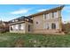 A home with a large backyard, deck, and multiple sliding glass doors at 1882 S Zinnia Way, Lakewood, CO 80228