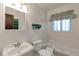 Bright bathroom with white fixtures including a sink, toilet, and shower/tub combo at 1882 S Zinnia Way, Lakewood, CO 80228