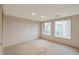 Bedroom with neutral wallpaper, carpet, and two windows for natural light at 1882 S Zinnia Way, Lakewood, CO 80228