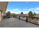 Large deck with black metal railings overlooking trees and houses in the distance at 1882 S Zinnia Way, Lakewood, CO 80228