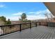 Large deck with black metal railings overlooking a distant mountain range and open space at 1882 S Zinnia Way, Lakewood, CO 80228