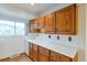 Kitchen with white countertops and wood cabinets, plus a window for natural light at 1882 S Zinnia Way, Lakewood, CO 80228