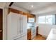 A kitchen with a large refrigerator, updated appliances, white cabinets, and tile countertops at 1882 S Zinnia Way, Lakewood, CO 80228