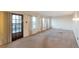A large living room features three windows, a door to the outside, and a white brick wall at 1882 S Zinnia Way, Lakewood, CO 80228