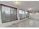 A sun room with light walls and ceiling, along with three large windows for natural light at 1882 S Zinnia Way, Lakewood, CO 80228
