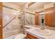 Bright bathroom with tiled walls, glass shower doors, and updated fixtures at 9365 W 80Th Pl # C, Arvada, CO 80005