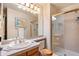 Bright bathroom with shower, framed mirror, and vanity with tile countertop at 9365 W 80Th Pl # C, Arvada, CO 80005