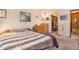 Bright bedroom with walk-in closet, warm lighting, and neutral decor at 9365 W 80Th Pl # C, Arvada, CO 80005