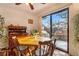 Bright dining area with wood table, chairs, and sliding glass doors to outdoor area at 9365 W 80Th Pl # C, Arvada, CO 80005