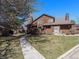 Beautiful exterior view of the home with mature trees, a walkway, and a well-maintained lawn at 9365 W 80Th Pl # C, Arvada, CO 80005