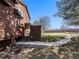 Back of home showing wood siding, patio, walkway, and manicured lawn at 9365 W 80Th Pl # C, Arvada, CO 80005