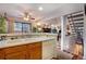 Kitchen with oak cabinetry, double sink, and open layout to living spaces at 9365 W 80Th Pl # C, Arvada, CO 80005
