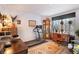 Cozy living room featuring a treadmill, traditional furniture, and a sunny window at 9365 W 80Th Pl # C, Arvada, CO 80005