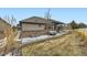 A house showcasing a stone foundation, well-maintained lawn, and covered patio area at 7214 S Shady Grove Ct, Aurora, CO 80016