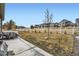 A backyard featuring a patio, lawn area, and white picket fence at 7214 S Shady Grove Ct, Aurora, CO 80016