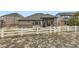A backyard featuring a white picket fence, grass area, and a home with a covered patio at 7214 S Shady Grove Ct, Aurora, CO 80016