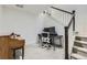 Basement office space with workspace, piano and access to stairs at 7214 S Shady Grove Ct, Aurora, CO 80016