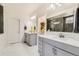 Bathroom with double vanity, marble countertop, and modern shower with rainfall showerhead at 7214 S Shady Grove Ct, Aurora, CO 80016