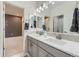 Bathroom featuring double sinks with a large mirror and decorative tile backsplash at 7214 S Shady Grove Ct, Aurora, CO 80016