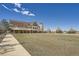 A large clubhouse building with expansive green lawn and sidewalk at 7214 S Shady Grove Ct, Aurora, CO 80016