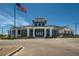 Community clubhouse featuring an American flag, stylish architecture, and well-maintained landscaping at 7214 S Shady Grove Ct, Aurora, CO 80016
