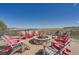 Cozy outdoor firepit area with Adirondack chairs and scenic water view at 7214 S Shady Grove Ct, Aurora, CO 80016