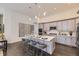 Modern kitchen with gray cabinets, a large island, and stainless steel appliances at 7214 S Shady Grove Ct, Aurora, CO 80016
