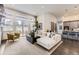 Bright living room featuring a comfortable sectional sofa, modern decor, and access to the outdoors at 7214 S Shady Grove Ct, Aurora, CO 80016