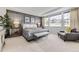 Relaxing main bedroom features a stylish accent wall and large windows with neighborhood views at 7214 S Shady Grove Ct, Aurora, CO 80016