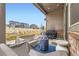 Covered patio area with seating, outdoor grills, and neighborhood views at 7214 S Shady Grove Ct, Aurora, CO 80016