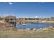 Scenic view of a pond featuring a dock and surrounding houses at 7214 S Shady Grove Ct, Aurora, CO 80016